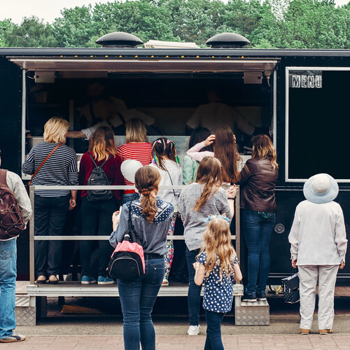 People gather at a food truck.