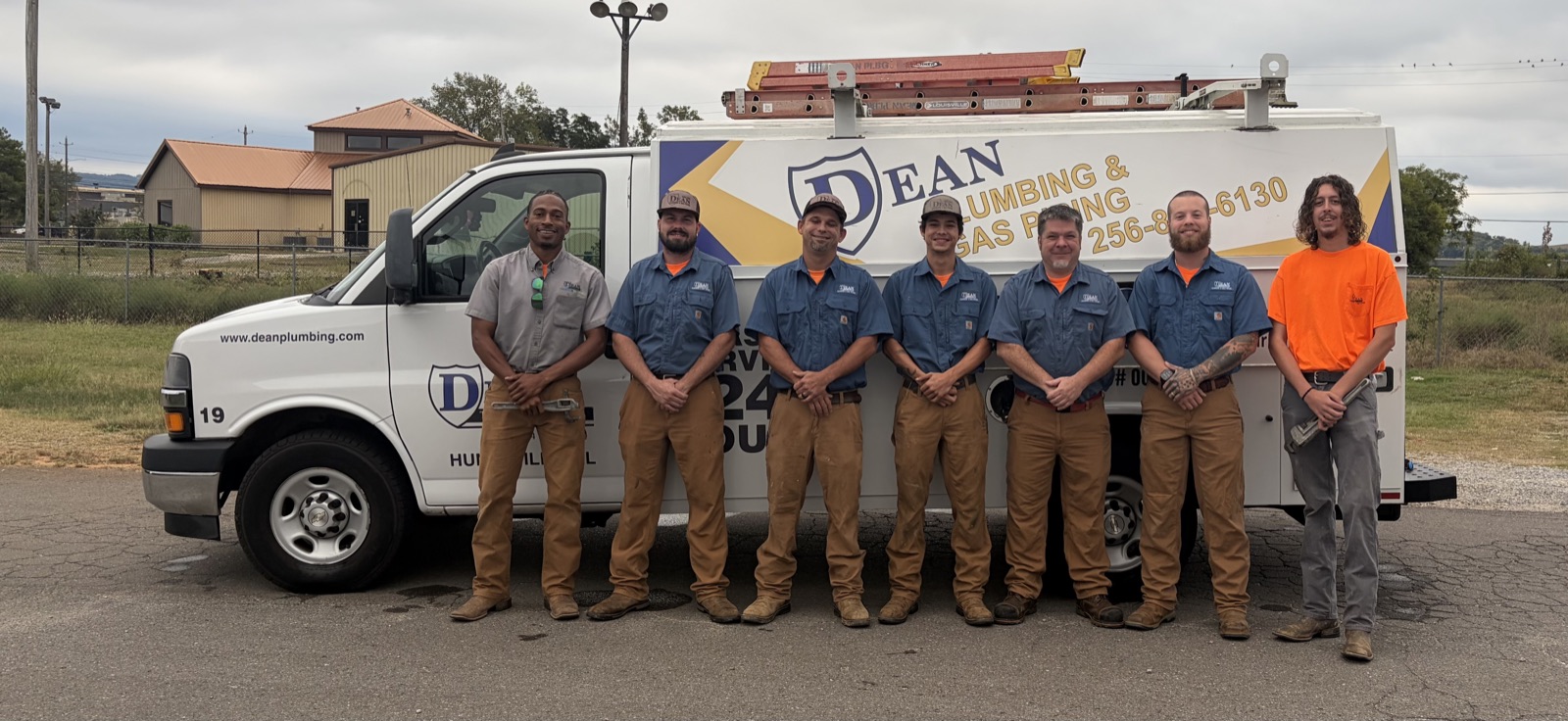 Dean Plumbing team with a service van